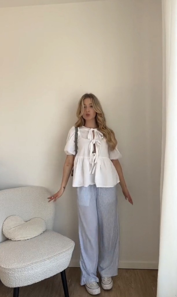 Swedish influencer Matilda Djerf, known for her sleek and feminine style, wearing stylish pajama pants in a room.